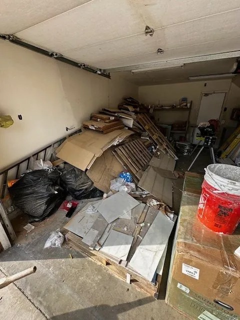 A cluttered garage filled with discarded items